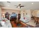Comfortable living room featuring modern decor, ceiling fan, and direct access to dining area at 26247 W Lone Cactus Dr, Buckeye, AZ 85396