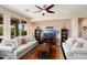 Spacious living room with plush sofas, a ceiling fan, and a large window for lots of natural light at 26247 W Lone Cactus Dr, Buckeye, AZ 85396