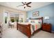 Inviting bedroom with a bay window, ceiling fan, and ample natural light at 26247 W Lone Cactus Dr, Buckeye, AZ 85396