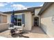 Cozy patio area with stylish outdoor seating, a bistro table, and easy access to the house at 26247 W Lone Cactus Dr, Buckeye, AZ 85396