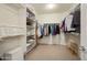 Spacious walk-in closet with built-in shelving and ample storage space for clothes and accessories at 26247 W Lone Cactus Dr, Buckeye, AZ 85396
