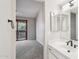 Modern bathroom with a white vanity, black fixtures, and view into a bedroom with balcony access at 2815 N 52Nd St # 3, Phoenix, AZ 85008