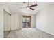 Neutral bedroom with a ceiling fan, closet, and sliding glass doors to a balcony at 2815 N 52Nd St # 3, Phoenix, AZ 85008