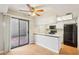 Bright kitchen with modern appliances, breakfast bar, and sliding glass doors to the patio at 2815 N 52Nd St # 3, Phoenix, AZ 85008