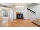 Open-concept living area with fireplace, wood floors, and a slider to the patio at 2815 N 52Nd St # 3, Phoenix, AZ 85008