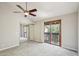 Bright main bedroom featuring a ceiling fan, sliding glass doors, and large closet at 2815 N 52Nd St # 3, Phoenix, AZ 85008