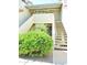 Condo exterior featuring a tidy garden, neutral colors, and easy access stairs at 30 E Brown Rd # 2113, Mesa, AZ 85201