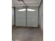 Spacious single-car garage featuring an overhead door with paneled windows and automatic door opener at 30 E Brown Rd # 2113, Mesa, AZ 85201