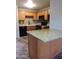 This kitchen features wooden cabinetry, black appliances, and granite countertops at 30 E Brown Rd # 2113, Mesa, AZ 85201