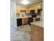 This kitchen features wooden cabinetry, black appliances, and granite countertops at 30 E Brown Rd # 2113, Mesa, AZ 85201