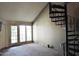 Living room featuring bright windows, neutral carpet, and a spiral staircase at 30 E Brown Rd # 2113, Mesa, AZ 85201