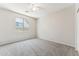 Bright bedroom featuring neutral walls, carpet, ceiling fan, and a window at 3310 W Chambers St, Phoenix, AZ 85041