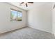 Bedroom with natural light, neutral walls, plush carpet, and ceiling fan at 3310 W Chambers St, Phoenix, AZ 85041