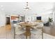 Eat-in kitchen and dining room featuring a breakfast bar, wood table and decorative chandelier at 3310 W Chambers St, Phoenix, AZ 85041