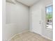 Bright entryway features neutral tile flooring, a white front door, and a window showcasing the exterior at 3310 W Chambers St, Phoenix, AZ 85041