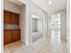 Spacious hallway with tile flooring, storage cabinets, and views into the living areas of the home at 3310 W Chambers St, Phoenix, AZ 85041