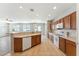 Open kitchen with wood cabinets, white appliances, and a breakfast bar perfect for entertaining at 3310 W Chambers St, Phoenix, AZ 85041
