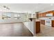 Well-lit kitchen with tile flooring, wooden cabinets, and a breakfast bar adjacent to the living area at 3310 W Chambers St, Phoenix, AZ 85041