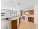 Open kitchen with wood cabinets, white appliances, and a breakfast bar perfect for entertaining at 3310 W Chambers St, Phoenix, AZ 85041