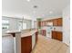 Open kitchen with wood cabinets, white appliances, and a breakfast bar perfect for entertaining at 3310 W Chambers St, Phoenix, AZ 85041