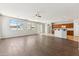 Bright and airy living room boasts hardwood floors, large windows, and a view into the kitchen at 3310 W Chambers St, Phoenix, AZ 85041
