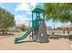 Outdoor playground with climbing wall, slide, and shaded seating area at 3310 W Chambers St, Phoenix, AZ 85041