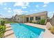 Backyard pool with patio, green lawn, and desert landscaping at 3310 W Chambers St, Phoenix, AZ 85041