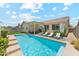Backyard pool with steps, patio, lounge chairs, and shade umbrellas at 3310 W Chambers St, Phoenix, AZ 85041