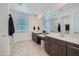Bright bathroom with dual vanities, dark wood cabinets, and large mirrors at 3340 S Lotus Ave, Mesa, AZ 85212