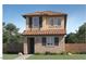 Charming two-story home featuring a stone facade, terracotta roof tiles, and classic window design at 3340 S Lotus Ave, Mesa, AZ 85212