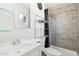 Updated bathroom featuring modern fixtures, a tiled shower, and a stylish vanity area at 3410 E Everett Dr, Phoenix, AZ 85032
