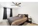 Comfortable bedroom featuring a ceiling fan, a plush bed with stylish linens, and natural light at 3410 E Everett Dr, Phoenix, AZ 85032