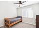 Simple bedroom with a wood frame bed, a ceiling fan, and natural lighting from a window at 3410 E Everett Dr, Phoenix, AZ 85032