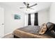 Serene bedroom with a ceiling fan, TV, and window with dark curtains for a cozy feel at 3410 E Everett Dr, Phoenix, AZ 85032