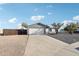 Charming single-story home with a two-car garage and a spacious driveway leading to a side gate at 3410 E Everett Dr, Phoenix, AZ 85032