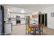 View of kitchen with stainless appliances, granite counters, white cabinets, and dining table at 3410 E Everett Dr, Phoenix, AZ 85032