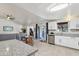 Open concept kitchen with granite counters, stainless appliances, and white cabinetry at 3410 E Everett Dr, Phoenix, AZ 85032