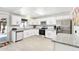Modern kitchen with white cabinetry, stainless steel appliances, granite countertops, and light wood-look flooring at 3410 E Everett Dr, Phoenix, AZ 85032