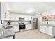 Modern kitchen featuring white cabinets, stainless steel appliances, and granite countertops, perfect for cooking and entertaining at 3410 E Everett Dr, Phoenix, AZ 85032