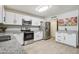 Bright kitchen with granite countertops, stainless steel appliances, and white cabinetry at 3410 E Everett Dr, Phoenix, AZ 85032