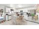 Modern kitchen with white cabinetry, stainless steel appliances, granite countertops, and dining at kitchen island at 3410 E Everett Dr, Phoenix, AZ 85032