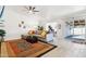 Bright living room with neutral decor, large area rug, sliding glass door, and open floor plan into other living spaces at 3410 E Everett Dr, Phoenix, AZ 85032
