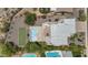The home's backyard with pool, patio, and green turf area are showcased in this aerial view at 3611 E Ahwatukee Dr, Phoenix, AZ 85044