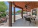 Covered back patio with ceiling fans, a stone table, and a view of the pool at 3611 E Ahwatukee Dr, Phoenix, AZ 85044