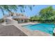 A serene backyard oasis featuring a pool and outdoor seating area at 3611 E Ahwatukee Dr, Phoenix, AZ 85044