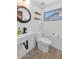 Bright bathroom featuring white fixtures, a modern sink, and a round, nautical-style mirror at 3611 E Ahwatukee Dr, Phoenix, AZ 85044