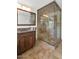 Bathroom with a glass-enclosed shower, stone-tiled walls, and a dark wood vanity at 3611 E Ahwatukee Dr, Phoenix, AZ 85044