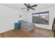 Bright bedroom featuring a ceiling fan, hard wood floors, and natural light at 3611 E Ahwatukee Dr, Phoenix, AZ 85044