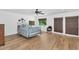 Spacious bedroom featuring hardwood floors, a metal frame bed, and sliding glass doors at 3611 E Ahwatukee Dr, Phoenix, AZ 85044