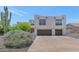 View of home showcasing a southwestern style home, desert landscaping, and a two-car garage at 3611 E Ahwatukee Dr, Phoenix, AZ 85044